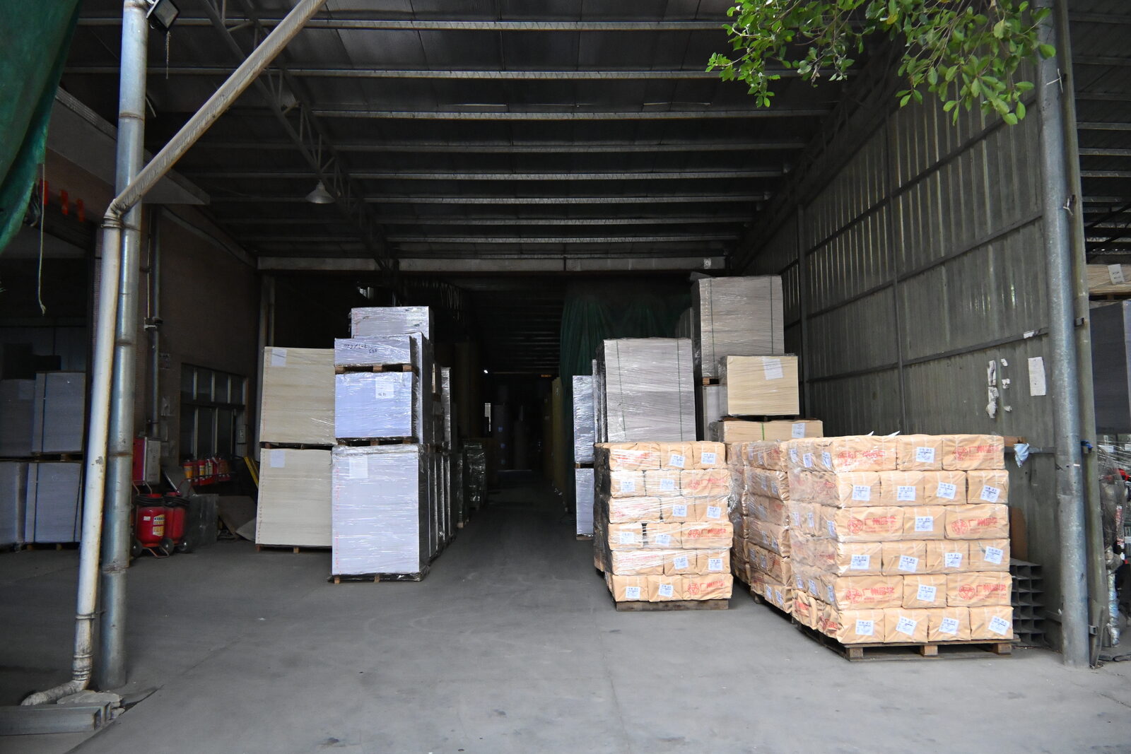 Paper stock and packed pallets in the QicaiPress warehouse