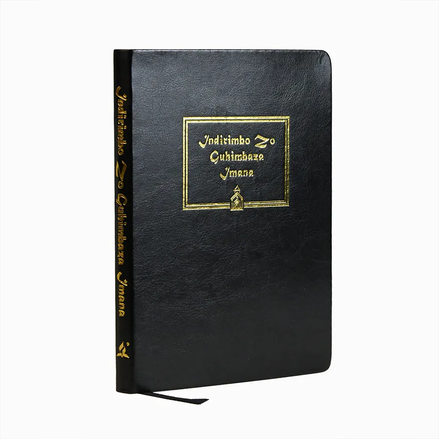 Black PU leather journal with gold debossed cover and ribbon marker, lying on a table