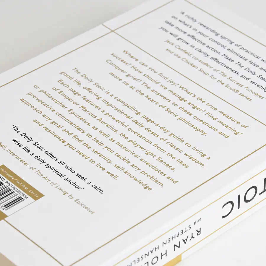 Hardcover back board with gold foil text and gilded book block