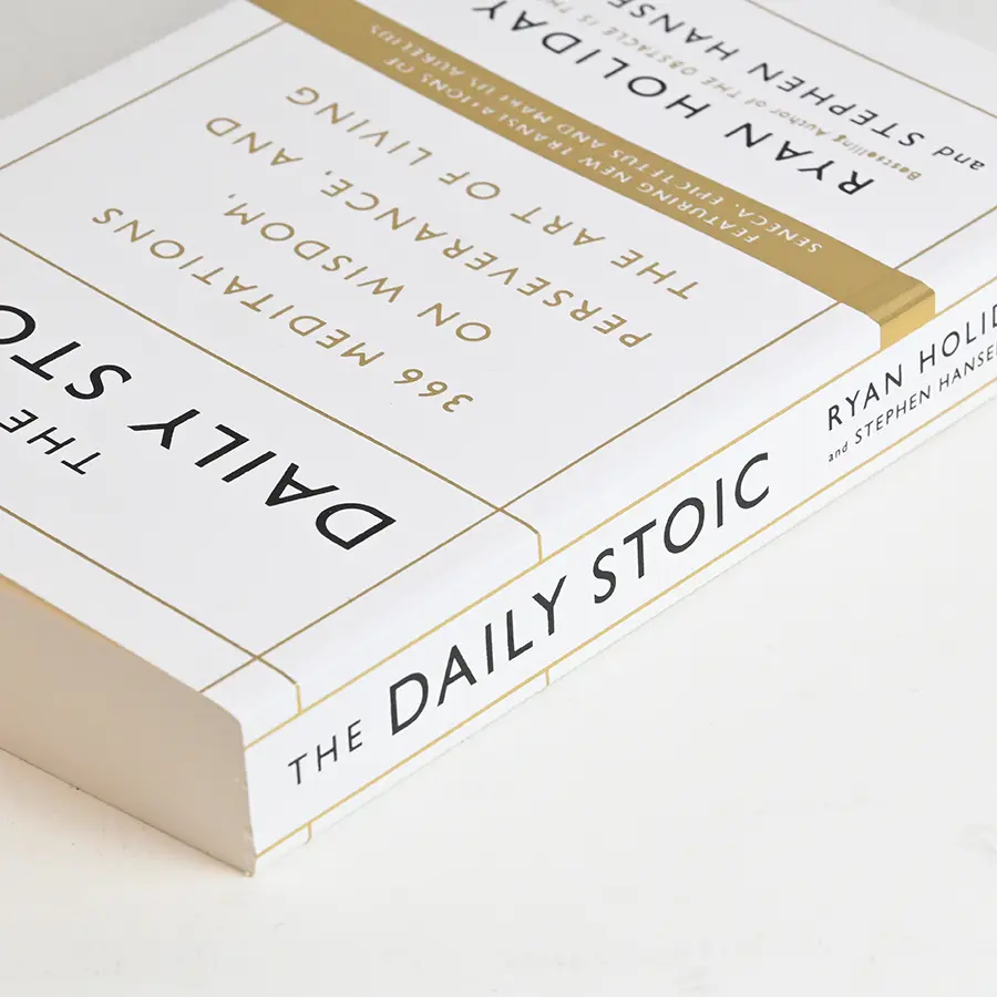 White case-bound volume with gold foil spine band